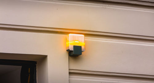 Low angle view of illuminated light against building
