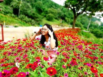 Woman with pink flowers on field
