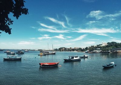 Boats moored in sea against sky