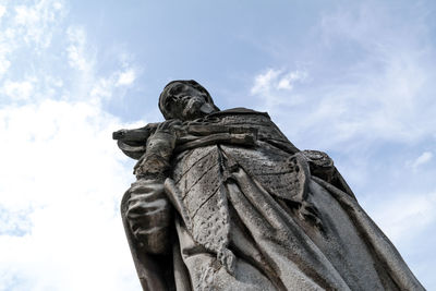 Statue against cloudy sky