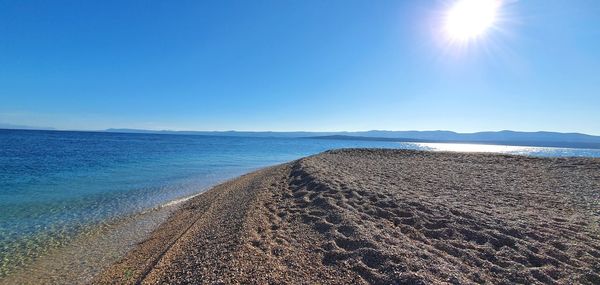 Scenic view of sea against clear blue sky