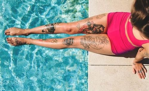 Midsection of woman relaxing in swimming pool