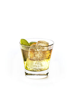 Glass of drink against white background