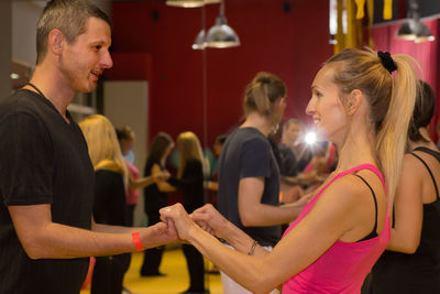 Side view of couple holding hands