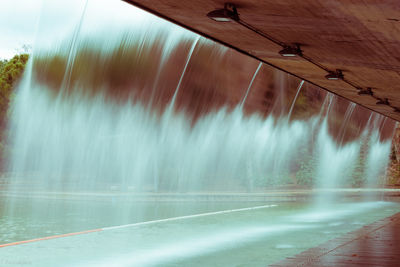 Scenic view of river flowing through car window