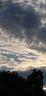 Low angle view of silhouette trees against sky during sunset