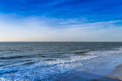 Scenic view of sea against blue sky