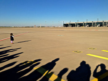 Shadow of people with girls standing on airport road