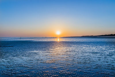 Scenic view of sea against clear sky during sunset