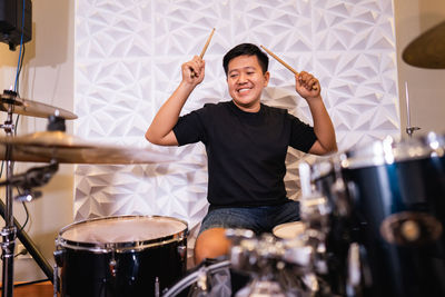 Young man playing drum