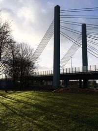 View of suspension bridge against cloudy sky