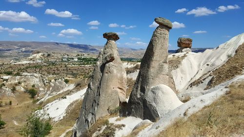 Rock formations on landscape against sky