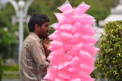 Full length of man holding pink flower