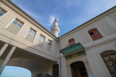 Low angle view of building against cloudy sky