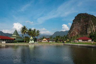 View of swimming pool by buildings against sky