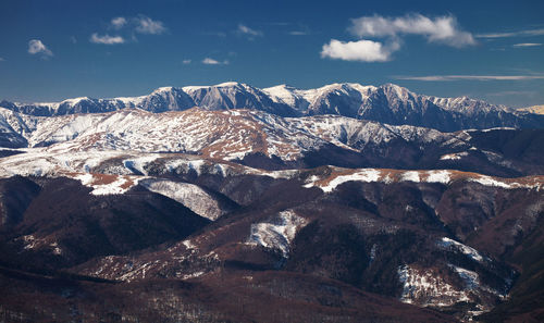 Low angle view of snowcapped mountains against sky