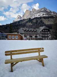 Built structure on snow covered mountain against sky