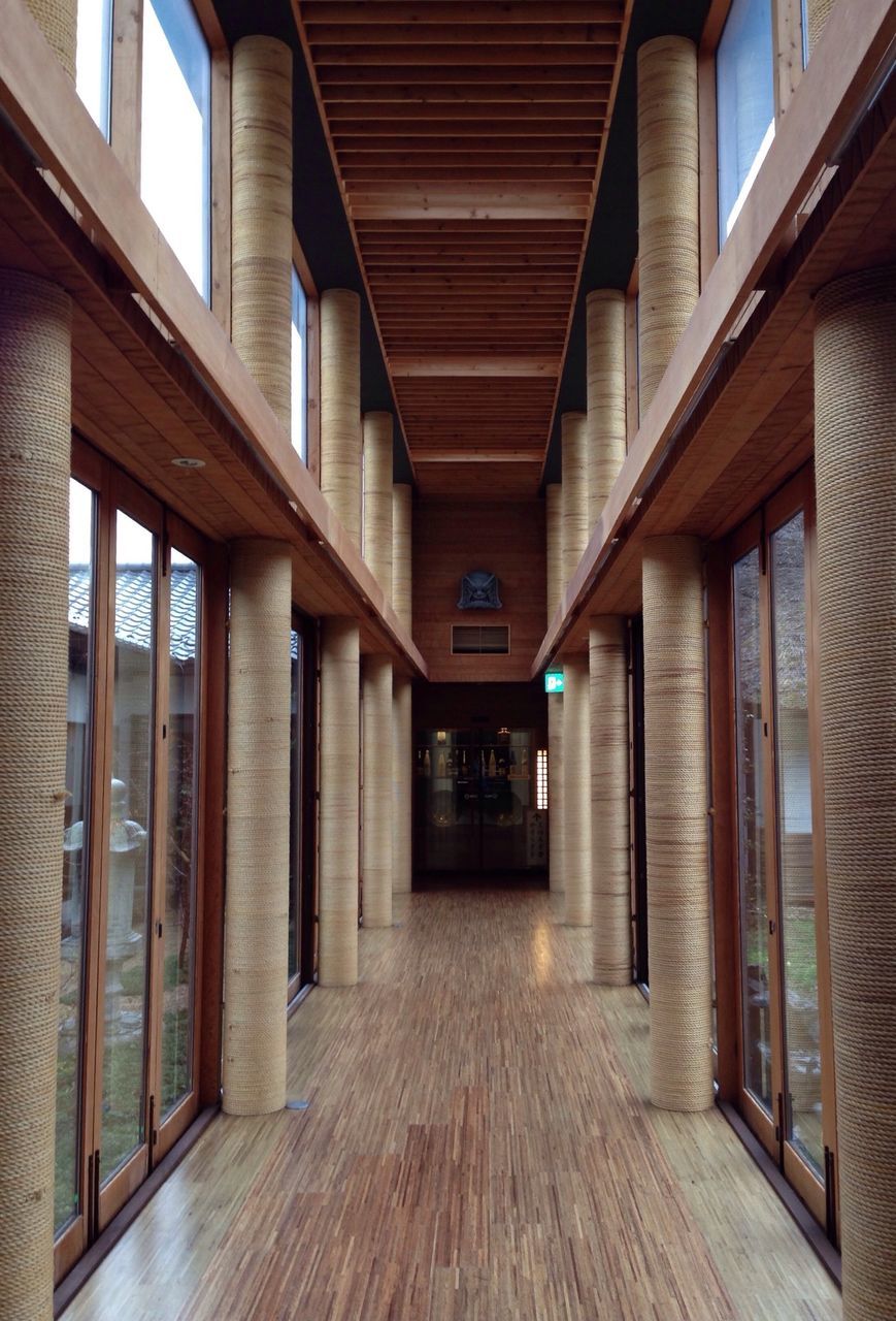 architecture, built structure, indoors, ceiling, building exterior, corridor, building, empty, architectural column, illuminated, the way forward, text, column, flooring, window, diminishing perspective, city, in a row, no people, absence