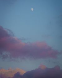 Low angle view of moon in sky at sunset