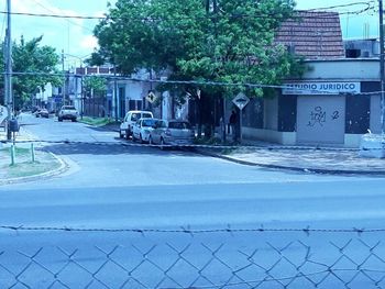 Cars on street by buildings in city