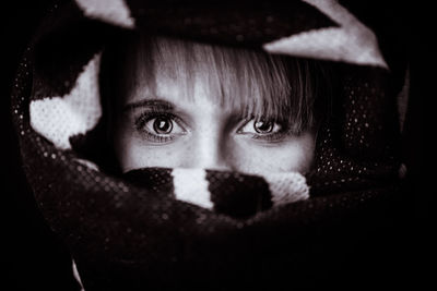 Close-up portrait of boy covering face