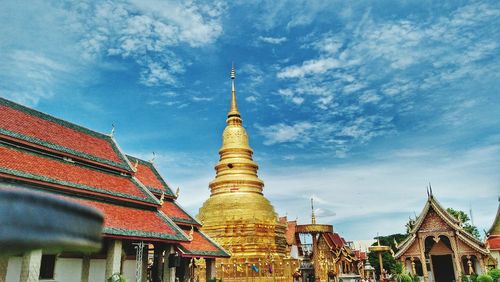 Low angle view of golden pagoda against sky