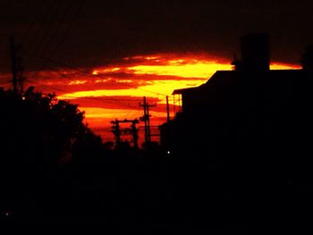 Silhouette of built structures at sunset