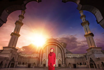 Low angle view of woman against sky during sunset