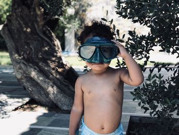 Portrait of toddler  wearing goggles while standing outdoors
