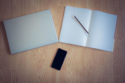 High angle view of pen and paper on table