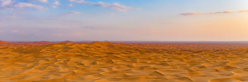 Scenic view of desert against sky during sunset