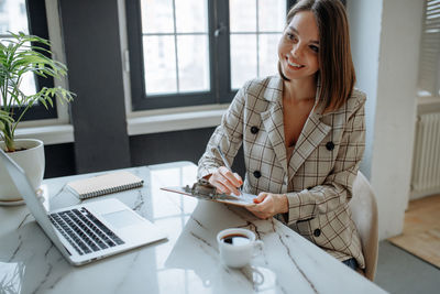 Young woman using laptop at home