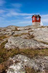 Low angle view of traditional windmill on mountain against sky