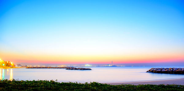 Scenic view of sea against clear sky at sunset