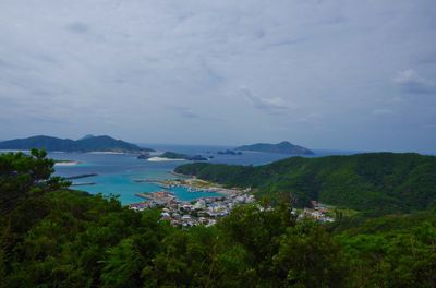 Scenic view of sea and mountains against sky