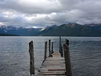 Pier over lake against mountains