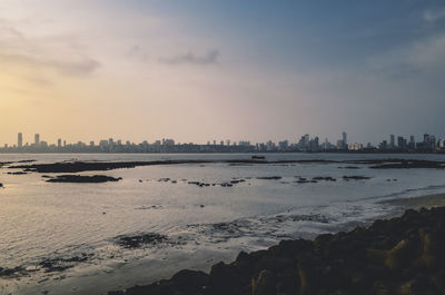 Scenic view of beach against sky during sunset