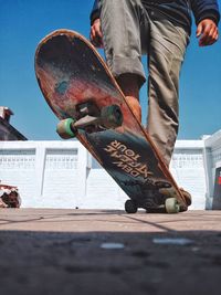 Low section of man with skateboard