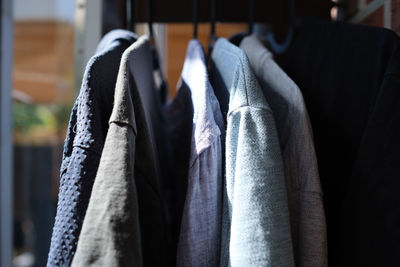 Close-up of clothes hanging on rack at store