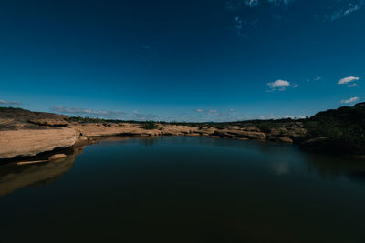 Scenic view of landscape against blue sky