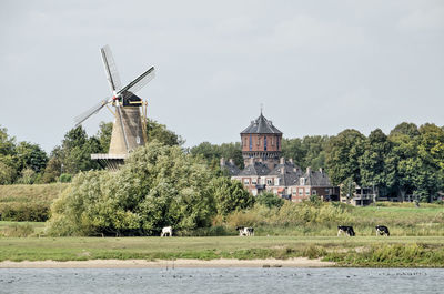 Dutch town with windmill seen from the river