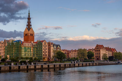 River amidst buildings against sky in city