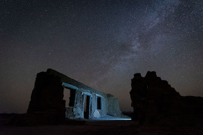 Scenic desert and mountain night under the stars and milky way with low angle building in texas