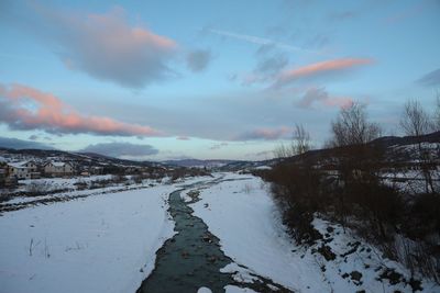 Scenic view of snowcapped landscape against sky