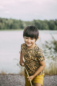 Portrait of smiling girl standing in water