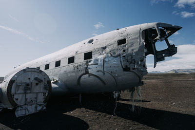 Airplane on field against sky