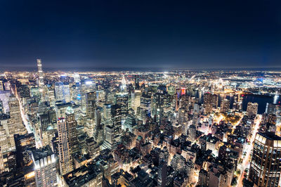 High angle view of illuminated city buildings at night