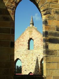 Low angle view of bell tower against sky