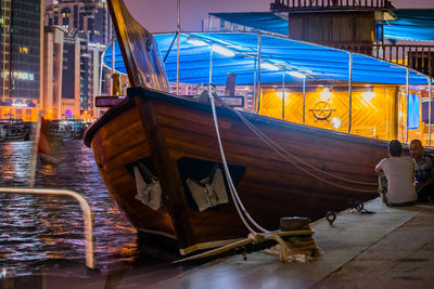 View of boats in city at night