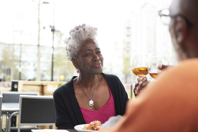 Portrait of woman drinking glasses on table at restaurant